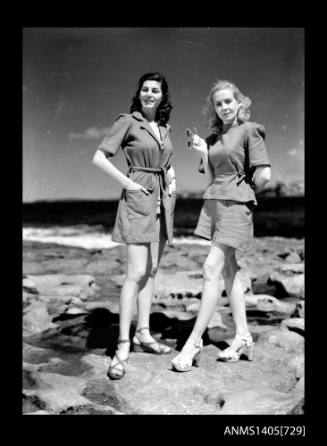 Negative depicting two women modelling beach wear