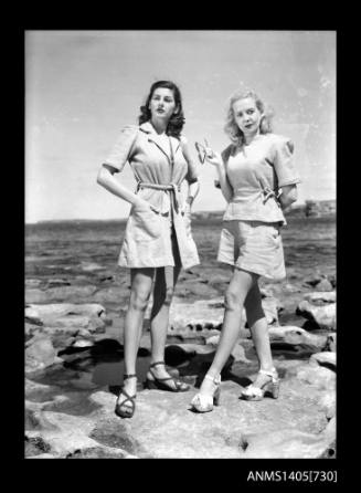 Negative depicting two women modelling beach wear