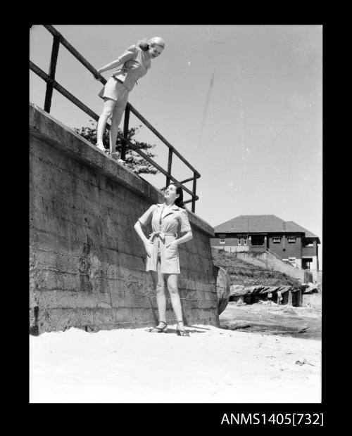 Negative depicting two women modelling beach wear