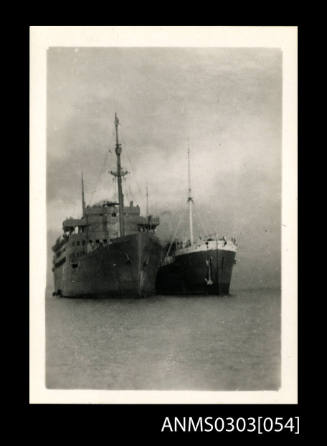 Two ships at Bandar Shapur, most likely HMS KANIMBLA (left) and German cargo ship HOHENFELS (right)