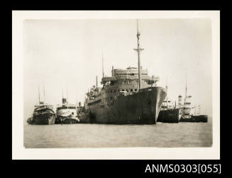 Row of six vessels side by side at the port of Bandar Shapur, 1941. The large centre ship is probably HMS KANIMBLA.
