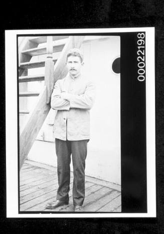 Unidentified man standing on a ship's deck