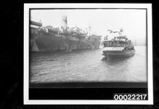 Sydney ferry SS KURING-GAI passing a passenger liner in dazzle camouflage