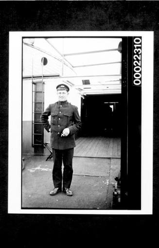 Ships and steamer crews, man standing on deck with a cigarette