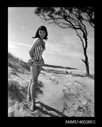 Woman modelling swimwear on beach