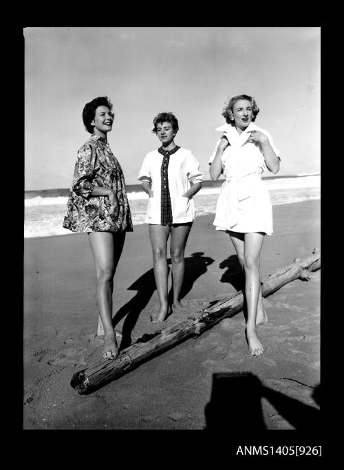 Negative depicting three women modelling beach wear