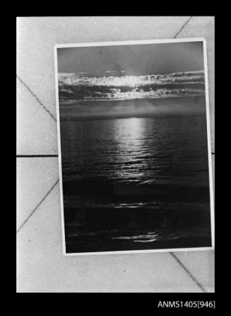 Negative depicting an image of a photograph of the moonlight over the ocean