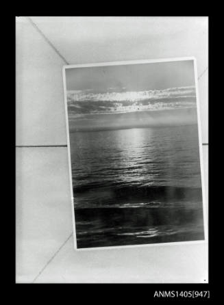 Negative depicting an image of a photograph of the moonlight over the ocean