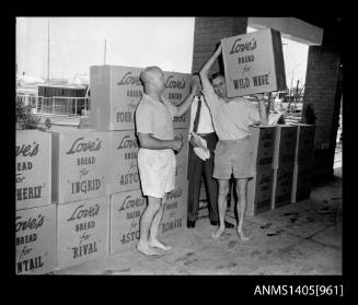 Man moving boxes of Love's bread