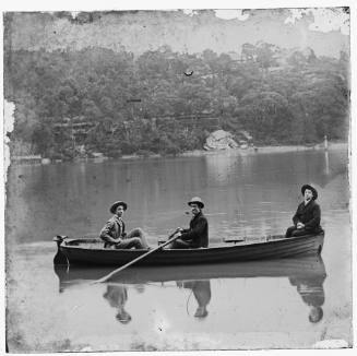 Three people in a rowing boat on Sydney Harbour