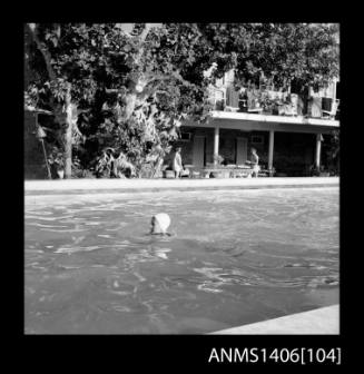 Negative depicting a woman in a swimming pool