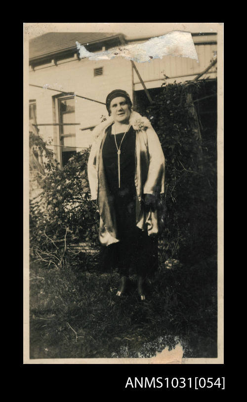 Woman standing in a backyard