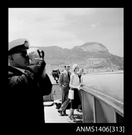 Negative depicting four people looking at the view from a P&O liner