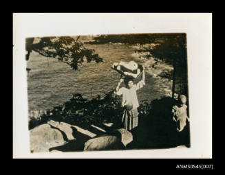 View of woman carrying a turtle shell on her head