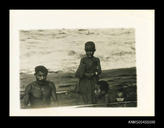 Man and three children on beach