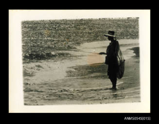 View of a man fishing on a beach