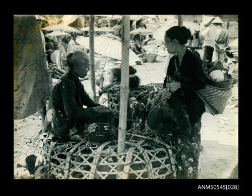 View of women at a chicken market stall