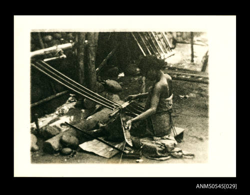 View of a woman weaving with a loom