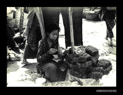 View of a woman selling at a market stall