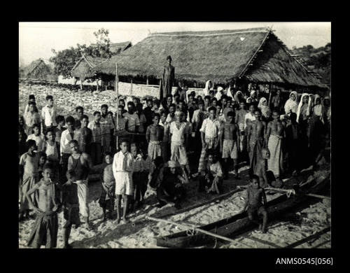 View of a group of people posing for the camera on a beach