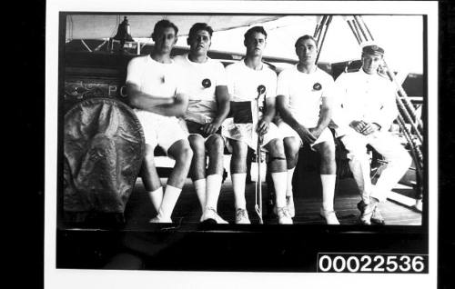 PORT JACKSON training ship - cadets in sports gear seated with an officer, one of the cadets holds the Devitt & Moore Line house flag