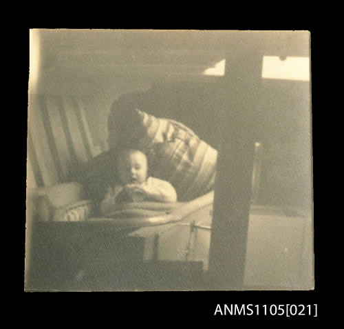 Barry Luke, son of Peter Luke, as a baby in a cradle