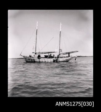 A side on view of a two masted boat in the water