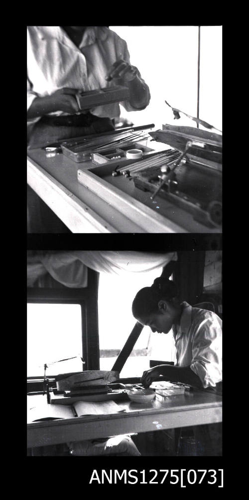 Yurie (or Yulie) George with sitting at a desk with pearl seeding equipment