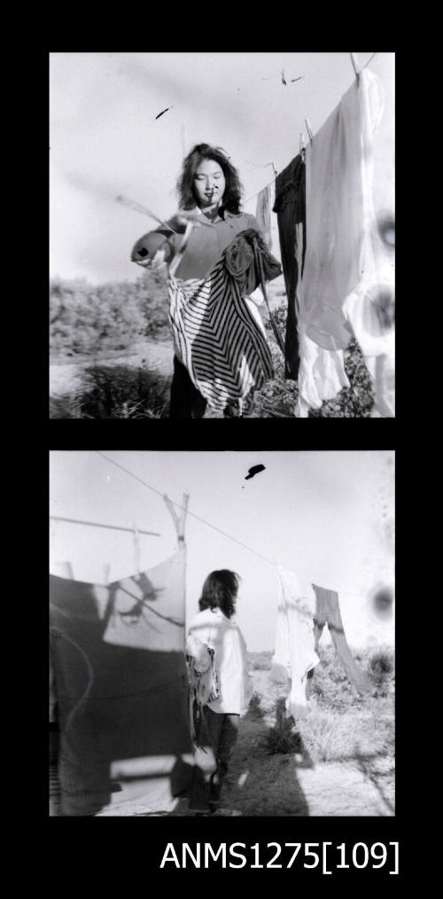 Two black-and-white negatives, joined together, of Yurie (or Yulie) George holding washing and standing next to the clothes line