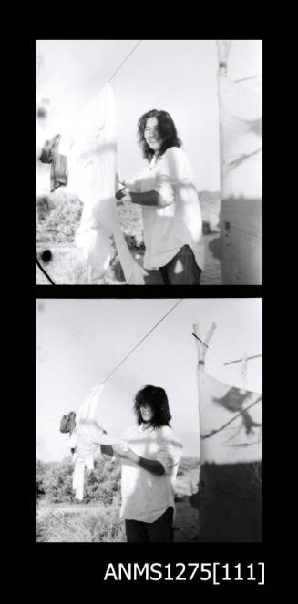 Yurie (or Yulie) George hanging washing on the clothes line