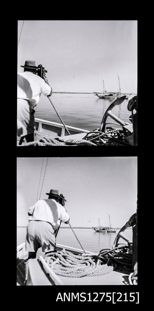 Two black-and-white negatives, joined together, both of  a man standing on a lugger, looking at a boat through a camera on a tripod