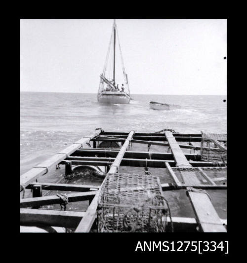 A pearl raft with pearl cages, with a boat in the background