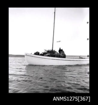 A side view of a boat carrying two people and pearl cages