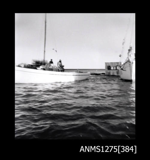 Boat filled with pearl cages pulling a pearl raft, with the boat RUBY DANA alongside the boat