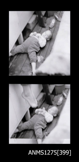 Two black-and-white negatives, joined together,both of a baby, possibly lying on the deck of a boat