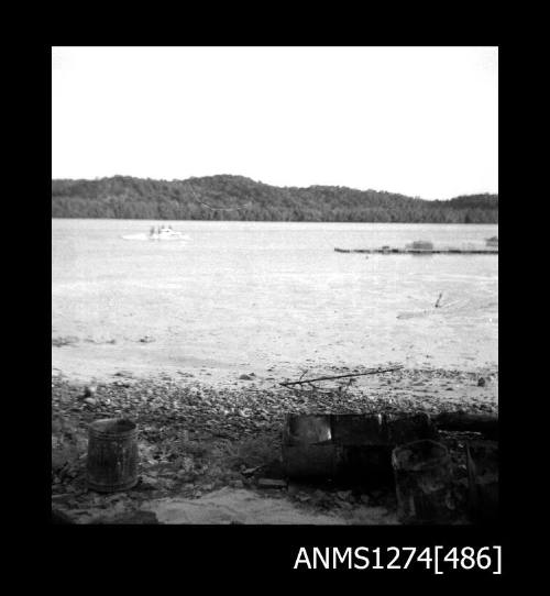 Equipment on a beach, and boats in the water, on Packe Island