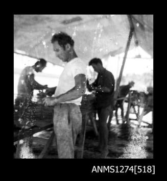 Three men constructing pearl cages on Packe Island