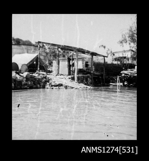 Sheds and a shade cover on the edge of the water on Packe Island