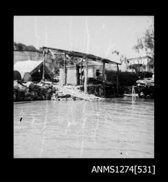 Sheds and a shade cover on the edge of the water on Packe Island