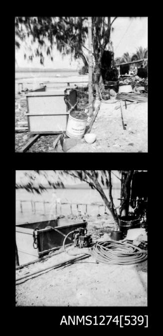 Two black-and-white negatives of tools and equipment sitting underneath a tree on Packe Island