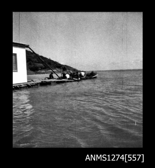 Several men working on a pearl raft on Packe Island