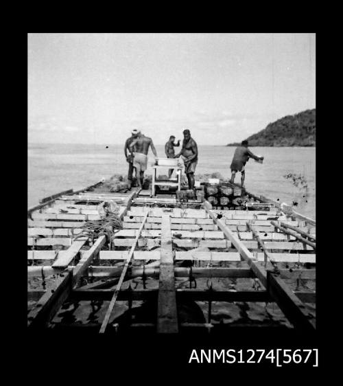 Several people working on a pearl raft on Packe Island