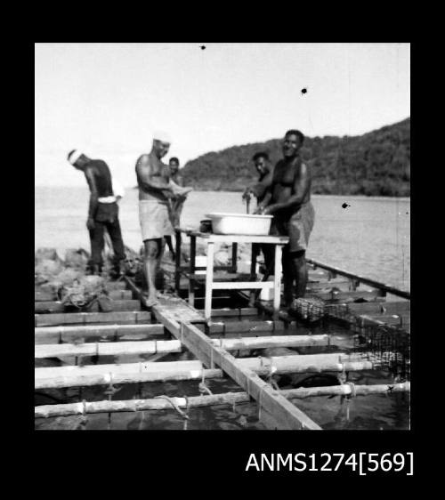 People standing on a pearl raft on Packe Island