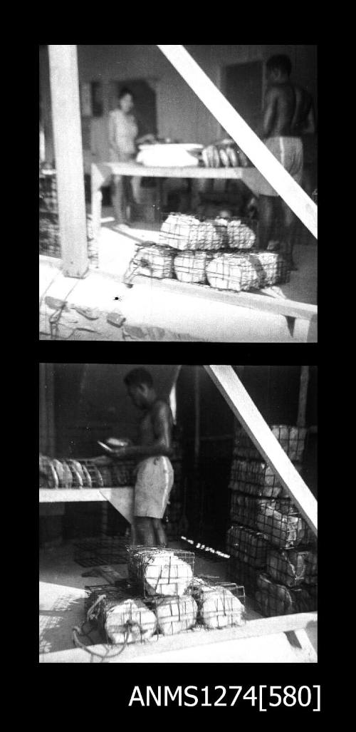 Two black-and-white negatives pearl cages, filled with pearl shells, sitting in a shed, with people in the shed, on Packe Island