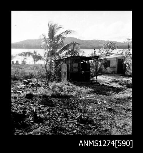 Two sheds, with palm trees nearby, on Packe Island