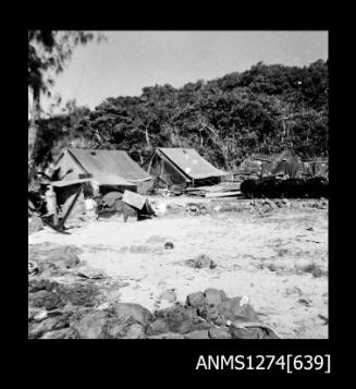 Two tents, and equipment, on the shoreline at Packe Island