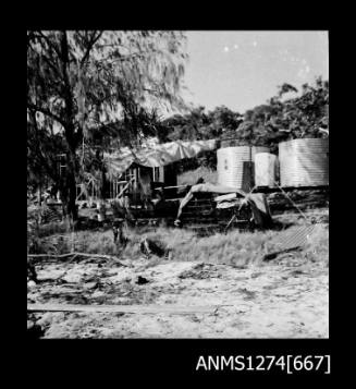 A semi-contructed building and large metal cylinders on Packe Island