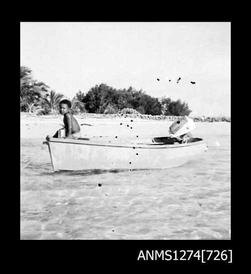 A person sitting at the front of a boat on Packe Island