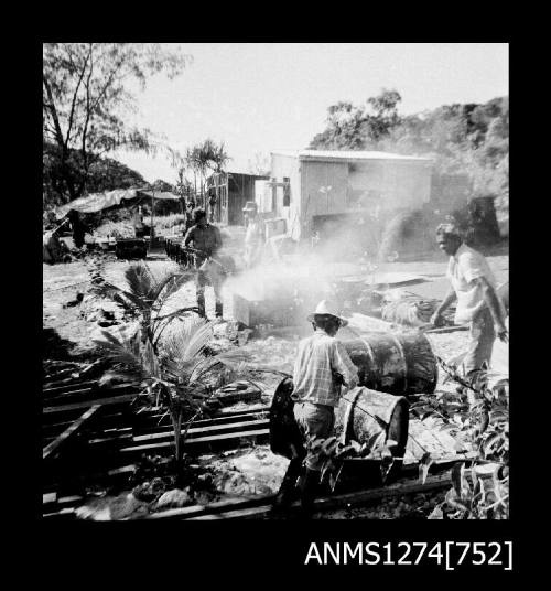 Tarring metal drums on Packe Island, Queensland Pearl Culture Company