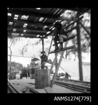 People constructing a shade cover on Packe Island